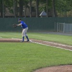 Scott Dickens watches on while coaching first base